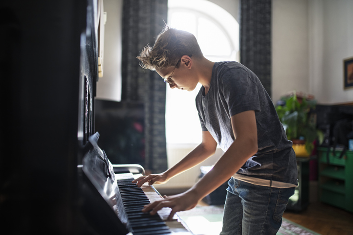 Teenage boy playing piano